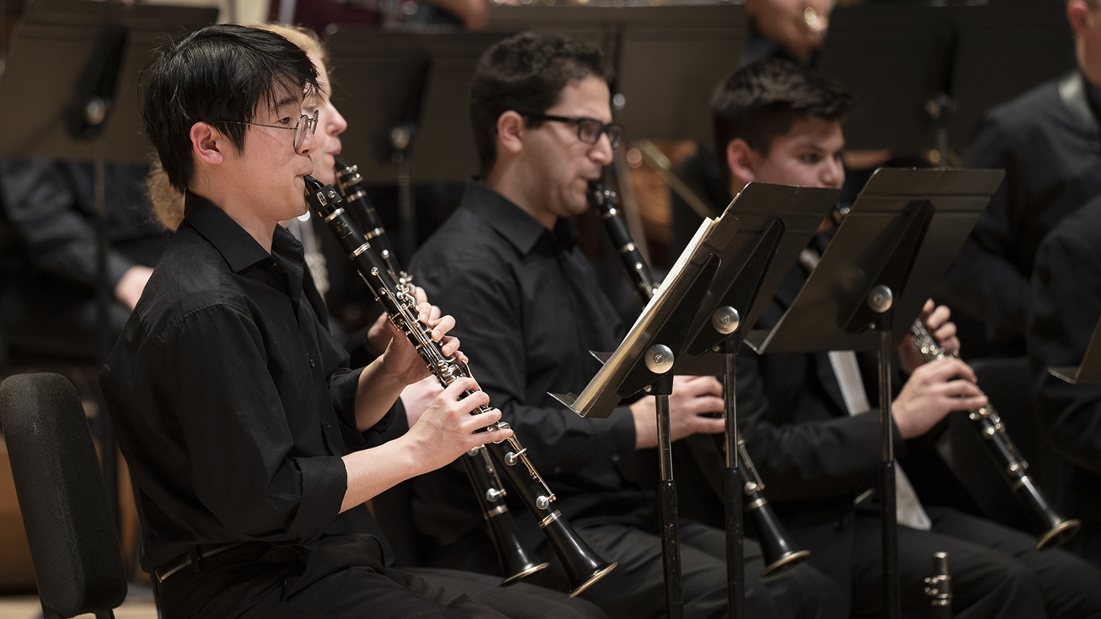 Close-up of clarinetists performing in an UMWO concert.