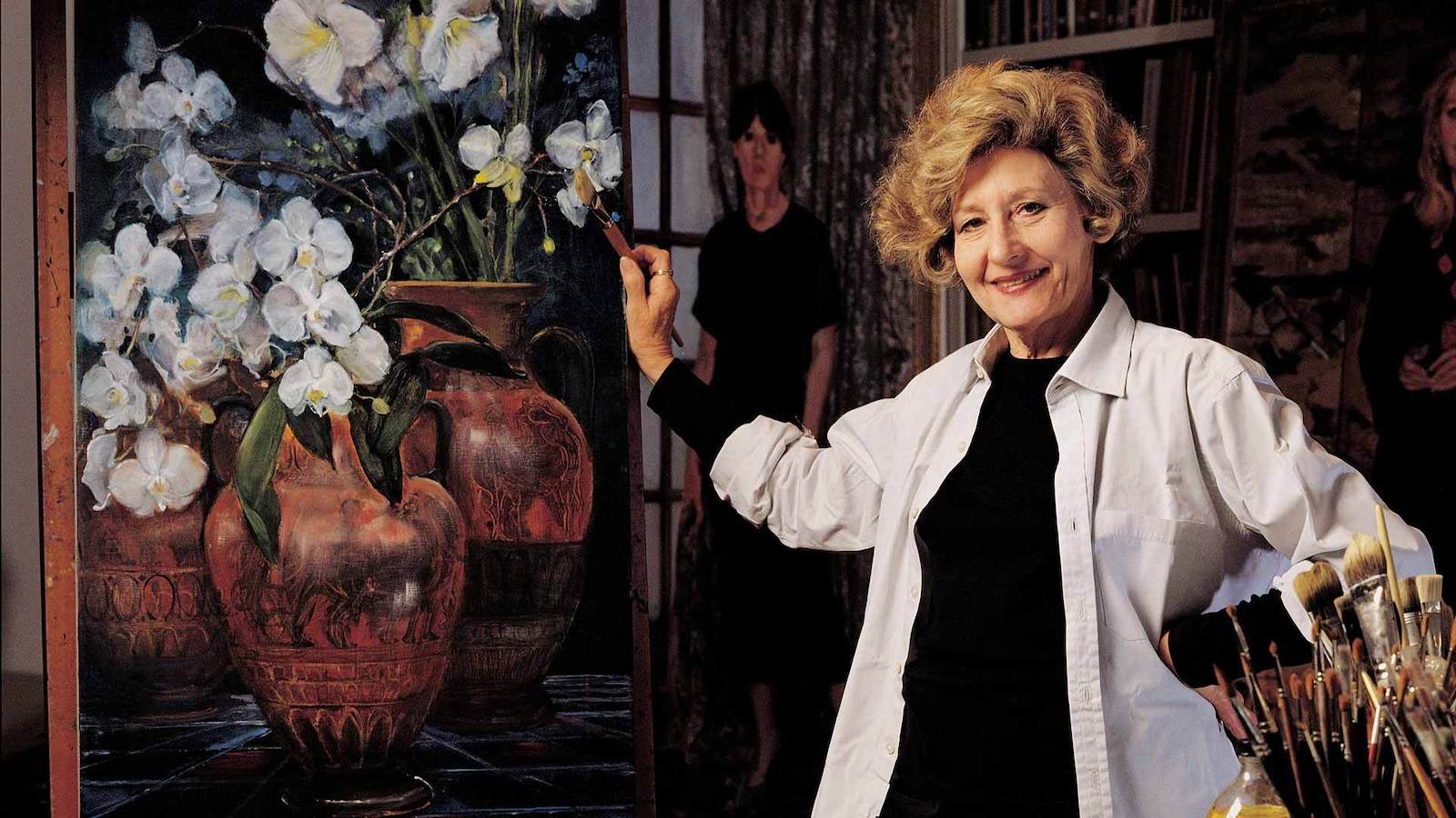 image of Clarice Smith with her paintings