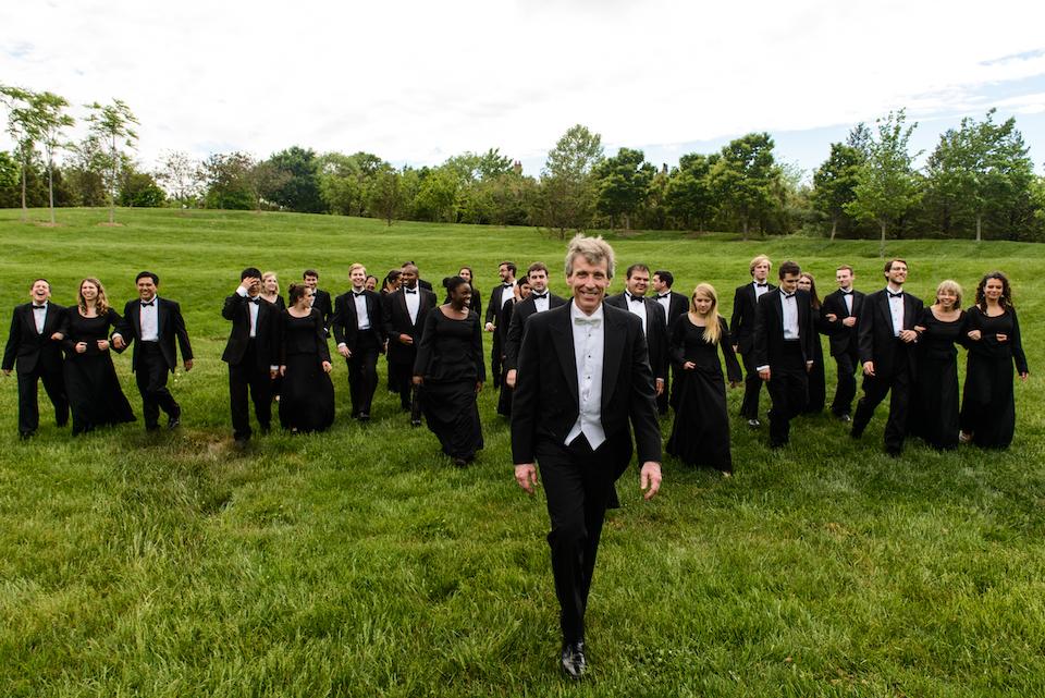  Professor Edward Maclary leads the UMD Chamber Singers across the grounds of The Clarice while wearing concert attire.