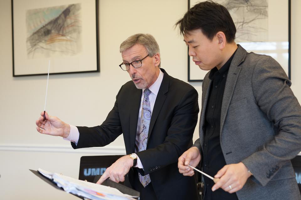  Professor Edward Maclary teaches graduate student Steve Kim.
