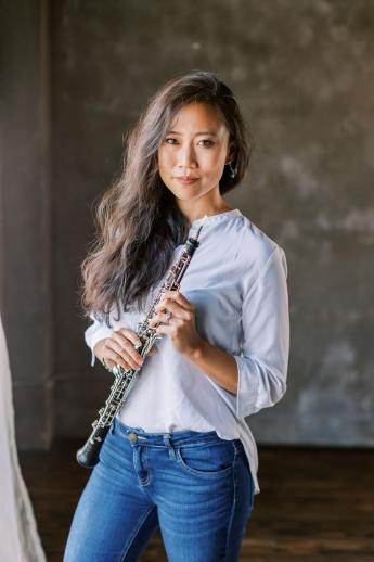 Emily Tsai holding her oboe.